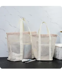 Detail of mesh storage tote bag with drawstring closure and marble background