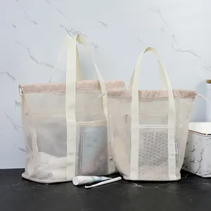 Cream mesh beach bag set with drawstring closure and reinforced handles for toiletries