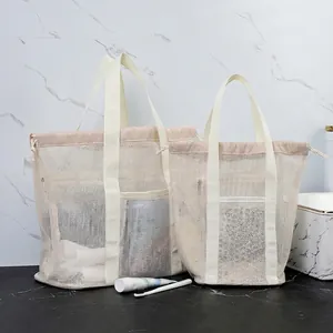 Cream mesh beach bag set with drawstring closure and reinforced handles for toiletries