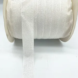 Macro detail of 2.5cm wide white velvet glitter ribbon roll for gift wrapping