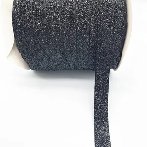 Close-up of 1cm black glitter velvet ribbon roll for gift wrapping and DIY crafts