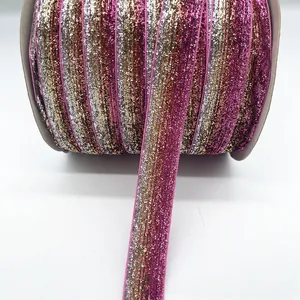 Detail of 1cm glitter velvet ribbons in pink, gold, and silver on rolls for DIY decor