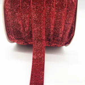Macro detail of red glitter velvet ribbon with shiny metallic texture for DIY gift wrapping