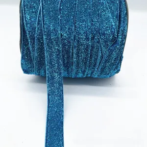 Close-up of 1cm blue glitter velvet ribbon roll for gift wrapping and DIY crafts