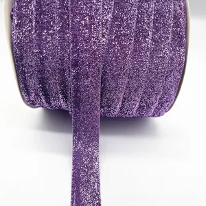 Detail of purple glitter velvet ribbon roll with sparkling texture for DIY crafts