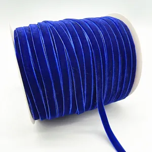 Single roll of 1cm royal blue velvet ribbon with metallic glitter on white spool