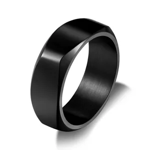 Macro shot of 8mm wide black titanium steel ring with polished finish and geometric facets
