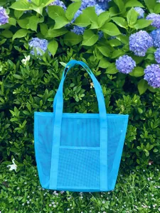 Detailed view of breathable blue mesh beach bag with reinforced straps and front pocket
