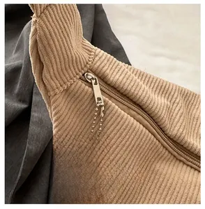 Detail view of khaki corduroy bag with smooth zipper and cloud shaped pendant charm
