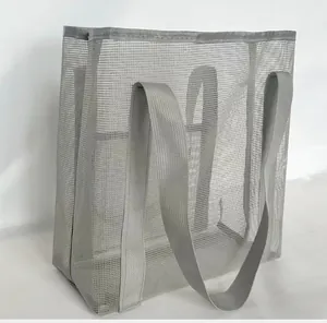 Close-up of a large grey mesh tote bag showing the breathable texture and sturdy handles
