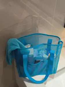 Detail view of a blue mesh beach bag showing breathable fabric and spacious compartments