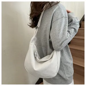 Detail of off-white corduroy crossbody bag with zipper and cute lamb plush charm