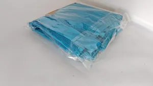 Blue mesh beach bag shown in original plastic packaging from a top-down view
