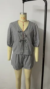 Detail of V-neck gingham two-piece set featuring delicate bow-ties and elastic waist shorts