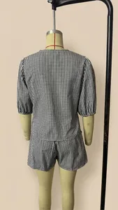 Rear view of women's black and white gingham two-piece set showing puff sleeves and shorts
