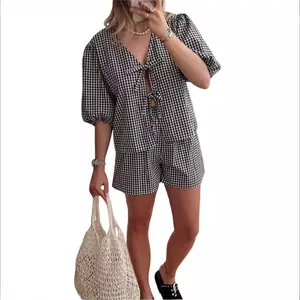 Women's black and white gingham two-piece set with bow-tie V-neck top and shorts