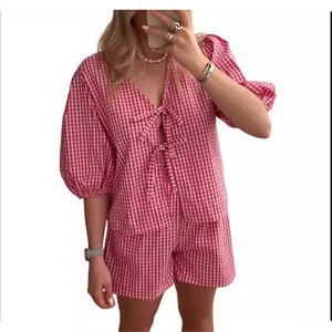 Women summer red gingham two-piece set featuring puff sleeve V-neck top and shorts
