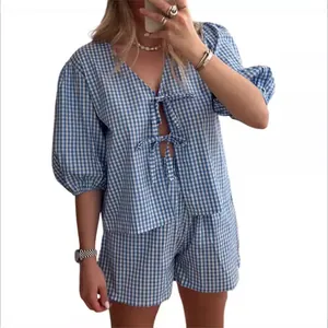 Blue and white gingham two-piece summer set with tie-front V-neck top and matching shorts