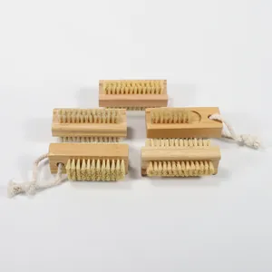 Detail view of five wooden and bamboo nail brushes with sisal bristles and hanging cords