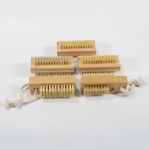 Detail of five natural wood nail brushes with sisal bristles and cotton hanging ropes