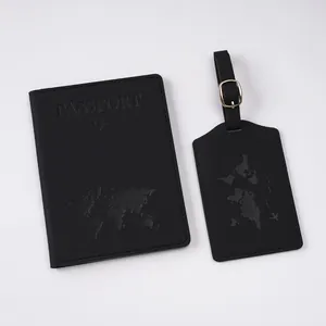 Detail of black leather passport cover and luggage tag with embossed world map and airplane