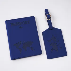 Detail of dark blue faux leather passport holder and luggage tag set with map embossing
