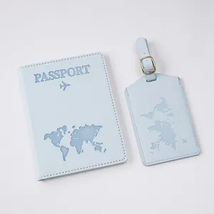 Detail of light blue textured world map passport cover and luggage tag with metal buckle