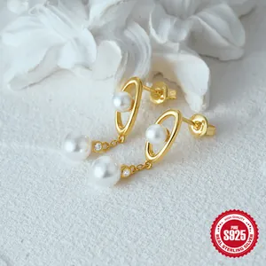Detailed view of S925 silver pearl drop earrings with gold plating and paved crystals