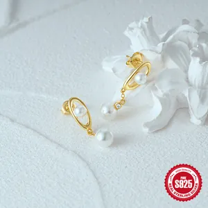 Detail of S925 sterling silver pearl earrings with minimalist oval gold ring and zircon