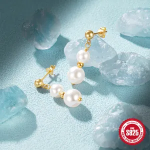 Detail of S925 sterling silver pearl earrings featuring a double pearl vertical design