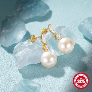 Detailed macro view of S925 hallmark on gold-plated silver pearl drop earrings