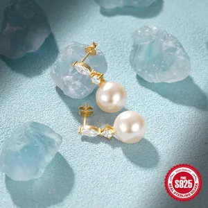 Macro shot of S925 sterling silver pearl earrings with marquise cubic zirconia details