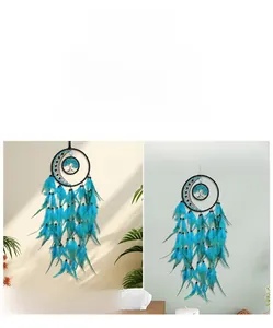 Detail of tree of life dreamcatcher with crescent moon and blue feathers