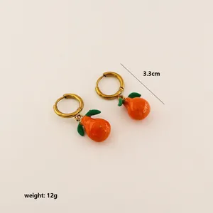 Detail view of 3.3cm orange slice earrings with gold hoops showing size and 12g weight