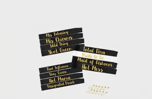 Detail view of satin bachelorette sashes with gold foil lettering and safety pins