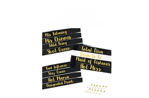 Detail view of satin bachelorette sashes with gold foil lettering and safety pins