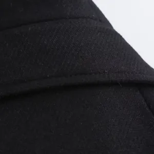 Close-up of black twill wool coat showing detailed stitching and fabric texture