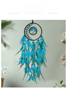 Detail of teal feathers and tree of life weaving on bohemian dream catcher hanging