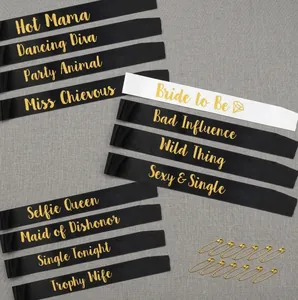 Close-up of 12-piece satin bridal party sash set with gold foil lettering and safety pins