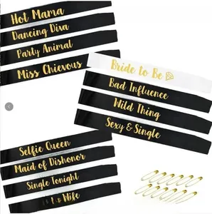 Close-up of 12-piece satin bridal party sash set with gold foil lettering and safety pins