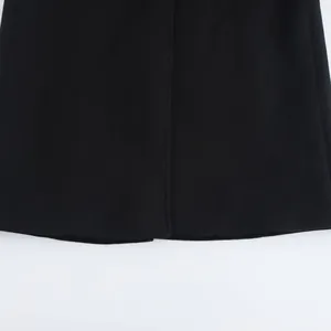 Detailed close-up of a premium black wool coat hemline with professional stitching