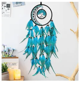 Macro detail of moon dreamcatcher featuring hand-woven tree of life and teal feathers