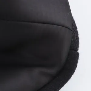 Macro view of wool blend coat texture and stitching details on black fabric