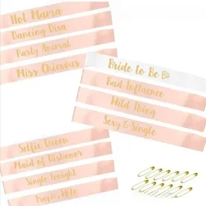 Detailed view of 12pcs Bride to Be and Bride Tribe satin sashes with gold safety pins