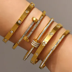Detailed view of five gold-plated bangles with pave crystals on a model's wrist