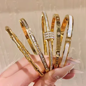 Set of five 18k gold plated stainless steel bangles with crystals and roman numerals