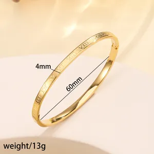 Macro detail of 4mm gold-plated titanium steel cuff featuring embossed Roman numerals