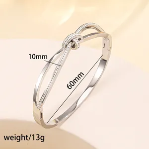 Macro detail of silver knot bracelet with crystal inlay and 60mm inner diameter dimension