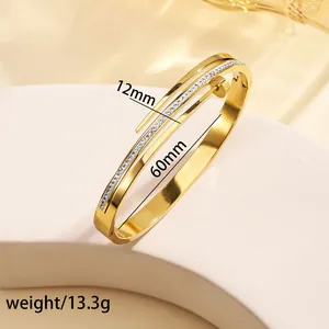 Detail shot of 18k gold plated stainless steel cuff with measurements and weight info