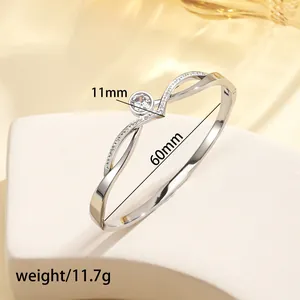 Detailed view of silver titanium steel bracelet with 11mm center crystal and open design